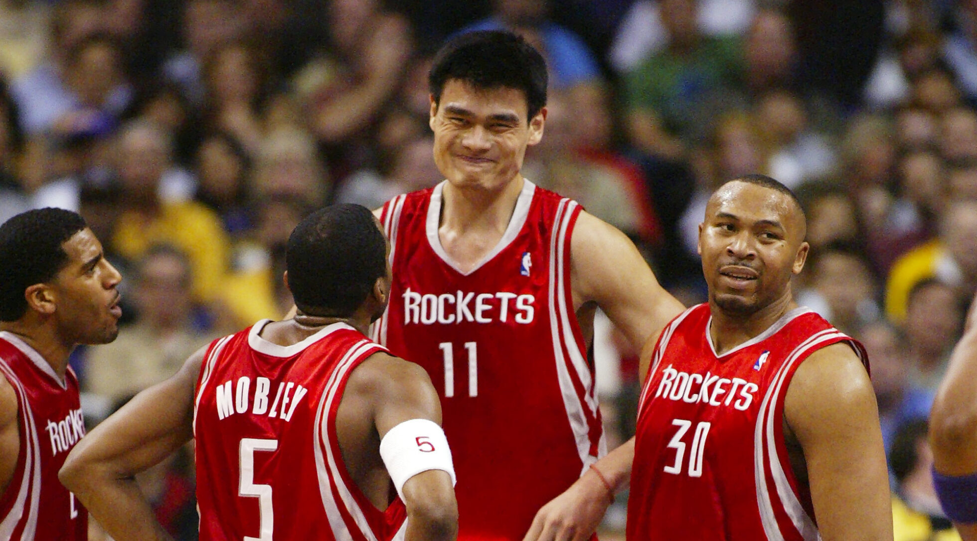 Yao Ming de los Houston Rockets habla con sus compañeros en Los Angeles 2004.
